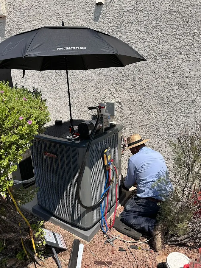 HVAC technician performing outdoor AC maintenance in Solvay